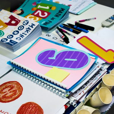kindergarten-students-workbooks-on-teacher-table-P6GHVYH.jpg